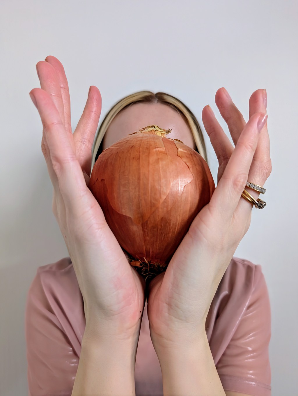 Rachael holding onion in front of face